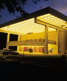 Nighttime lighting bathes the front of Kennedy Theatre in a golden glow
