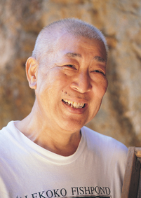 Head shot of a smiling man with close-cropped hair