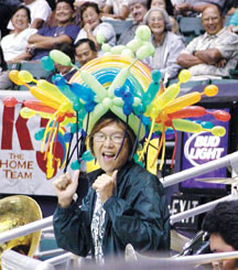 UH Manoa Assistant Band Director Gwen Nakamura with colorful balloon head-dress