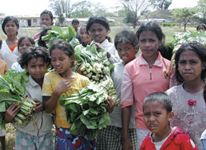kids in Eat Timor with vegetables for sale