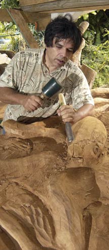 sculptor and woodcarver Tonu Shane Eagleton carving a large block of wood