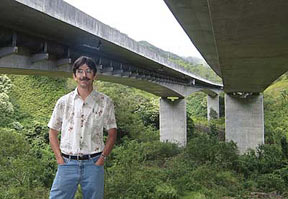 UH Manoa Professor of Civil and Environmental Engineering Ian Robertson standing under a bridges