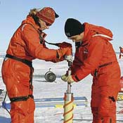 scientists taking core samples of ice