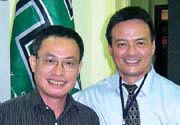 Hanoi University President Nguyen Xuan Vang, left, with Alumni Relation's Kevin Takamori