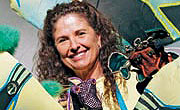 Tamara Montgomery surrounded by colorful theater props and costumes, click for story