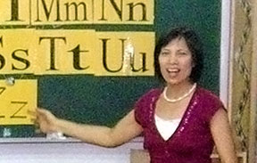 woman Apay Tang standing at blackboard