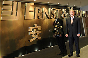 Jim Hassett in front of company sign