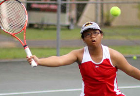 woman Kelsey Daguio swinging at a tennis ball