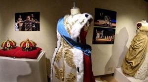 Costumes, instruments, props and production photographs are on display.