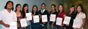 Imi grads holding their JABSOM acceptance letters.