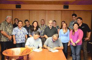 NDPTC’s Karl Kim and Daniel Wildcat of Haskell Indian Nations University sign agreement.