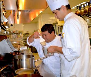Chef faculty Mark Oyama instructs his students in a culinary arts class.