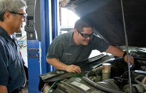 student mechanic under hood