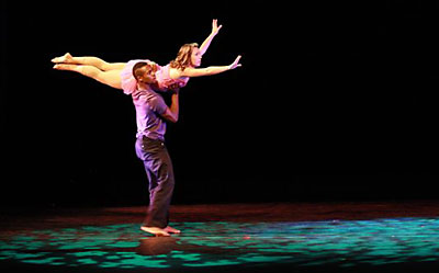 two people dancing on stage