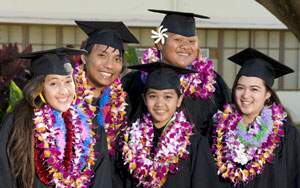 students in graduation garb and lei