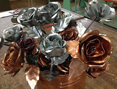 Sheet metal and copper roses on sale. 