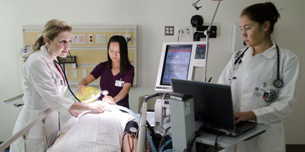 nursing students practicing on a dummy patient