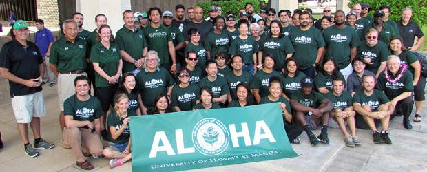 staff posing with ALOHA banner