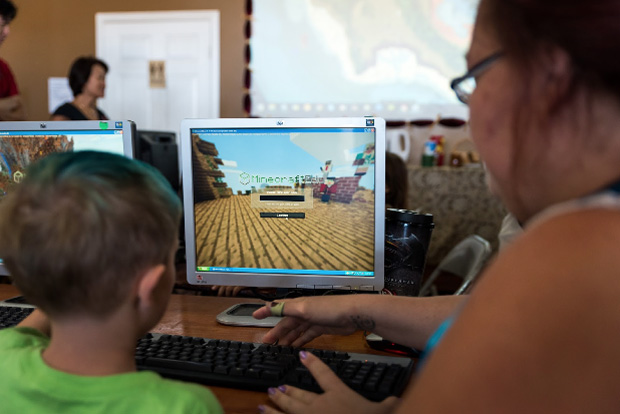 Child and parent playing Minecraft