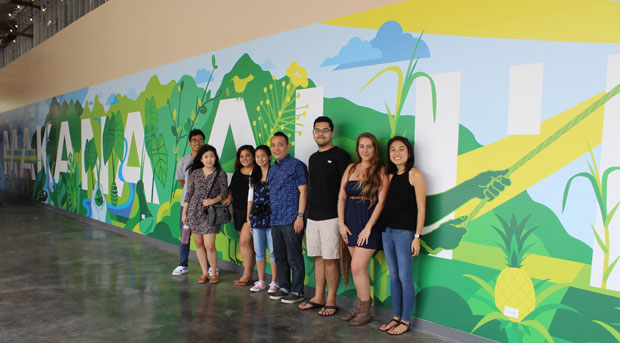Student artists standing in front of their mural at Ka Makana Alii