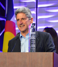 David Lassner at a podium accepting an award