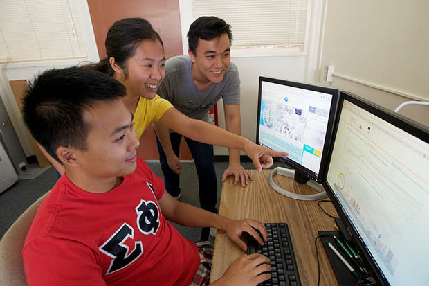 Students around two computer screens