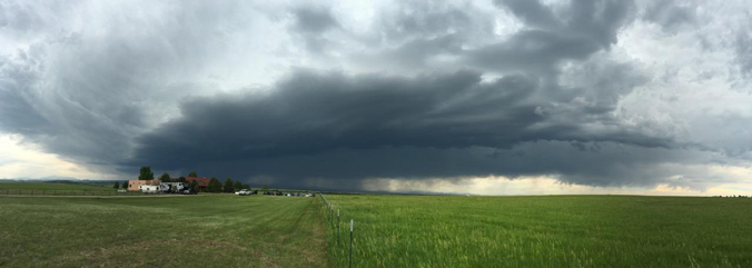 black storm clouds over farmland
