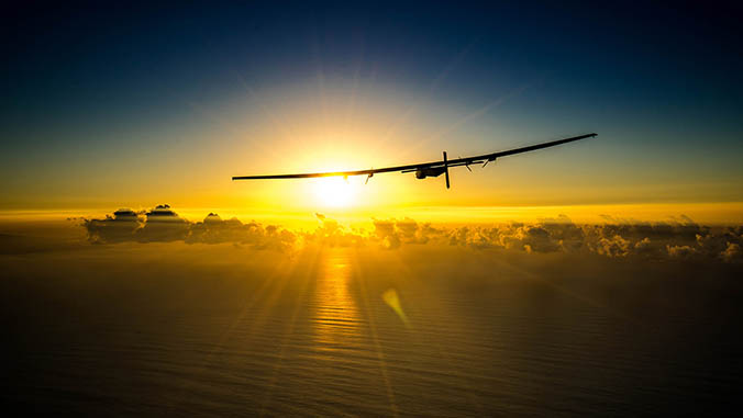 The Solar Impulse 2 flying over the ocean toward the sun