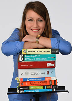 Svrcina leaning atop a stack of books