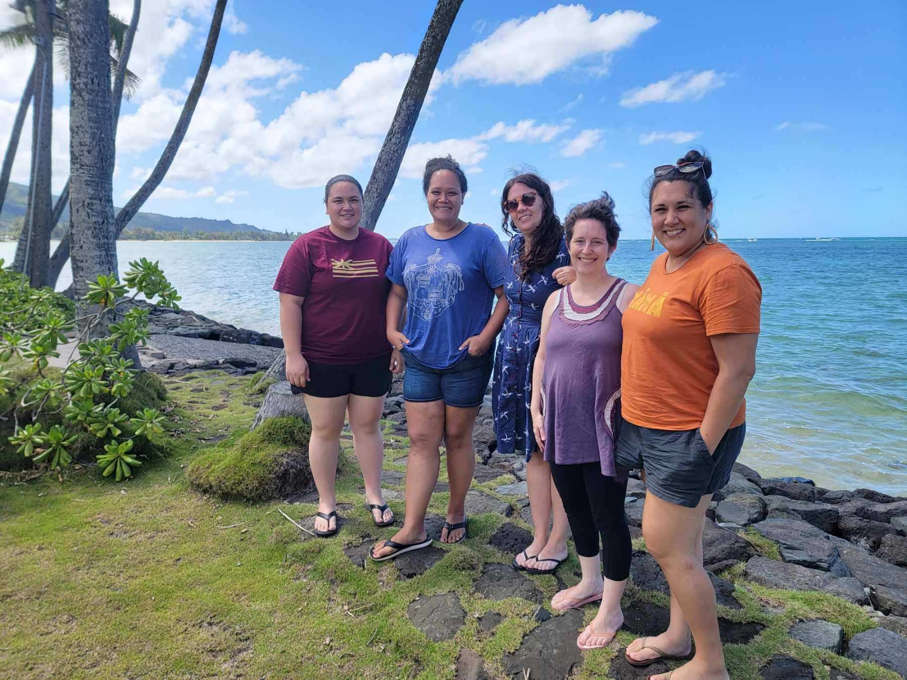Project team members standing next to Punaluʻu ocean