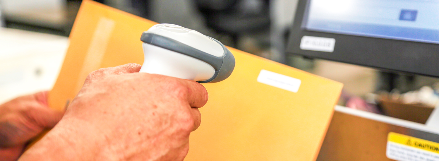 Campus Mail worker scanning a mail barcode