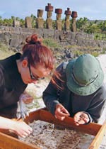 archeologists with moai in the background