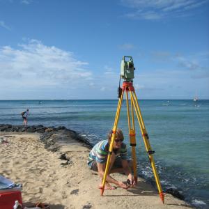 SOEST geoscientist sets up beach profile equipment. Credit: SOEST/UHM.
