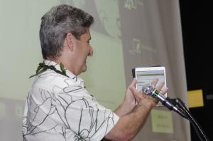 President David Lassner signed the University of Hawai‘i's new sustainability policy on his ipad.