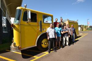 Fire Science students and professors pose with the truck belonging to the fire science program.