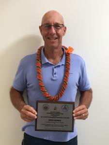 Ross Barnes holding the recognition plaque from the State of Hawai‘i. Credit: UHMC.