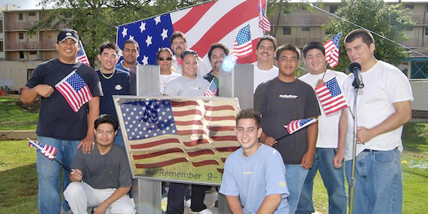 students standing in front of flag