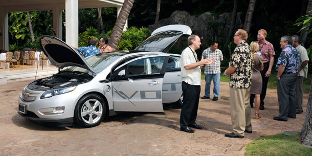 People looking at an electric vehicle