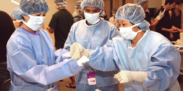 medical students in surgical gowns