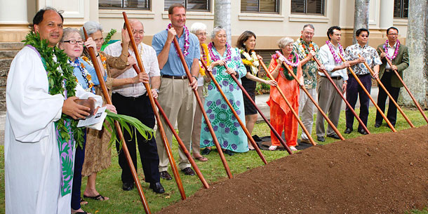 group of people with stick in dirt