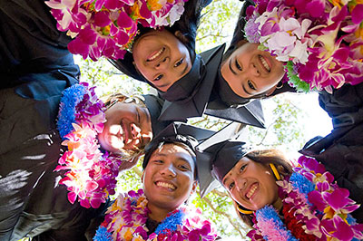Group of students in graduation robes and leis