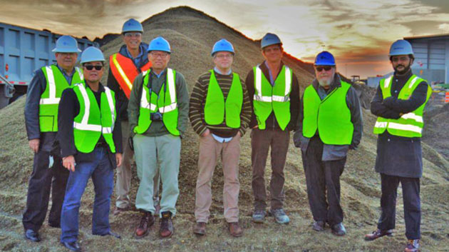 men with neon jackets standing in a row