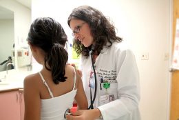 JABSOM doctor examining child