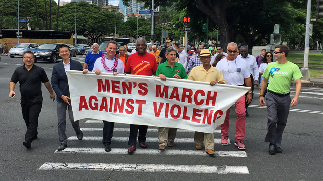 people holding large Men's March sign