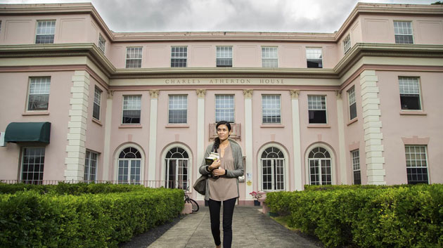 Woman in front of the Atherton building