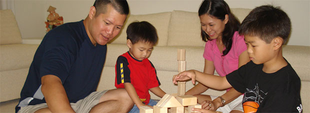 Family playing with blocks in a living room