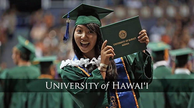 A happy UH Manoa graduate holding her diploma