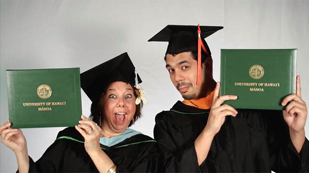 Two happy graduates with their diplomas