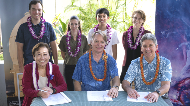 3 people signing mou and four people standing