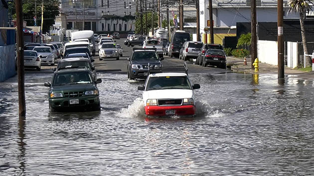 Car driving through flooded street